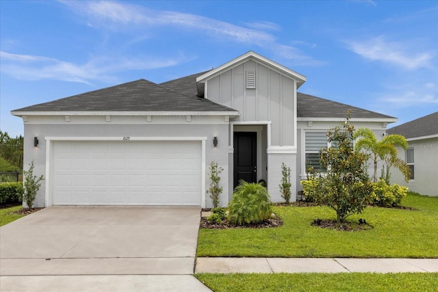 view of front of house with a front yard and a garage