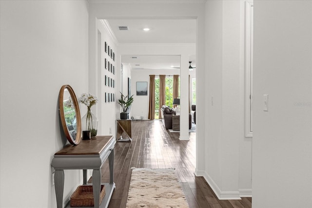 hallway with dark hardwood / wood-style flooring and ornamental molding