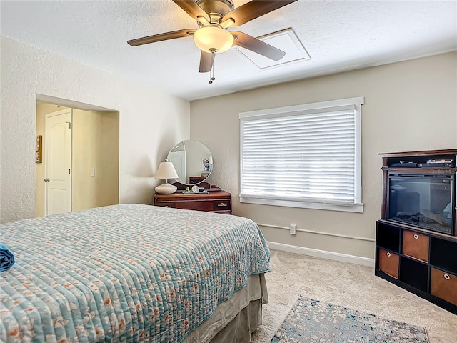 carpeted bedroom with a textured ceiling and ceiling fan