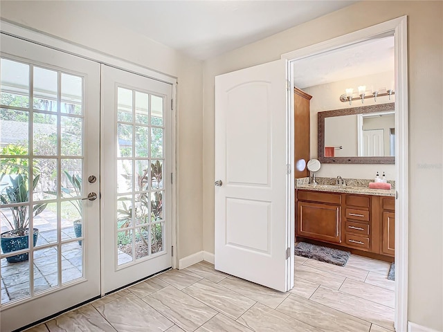 doorway to outside with french doors and sink