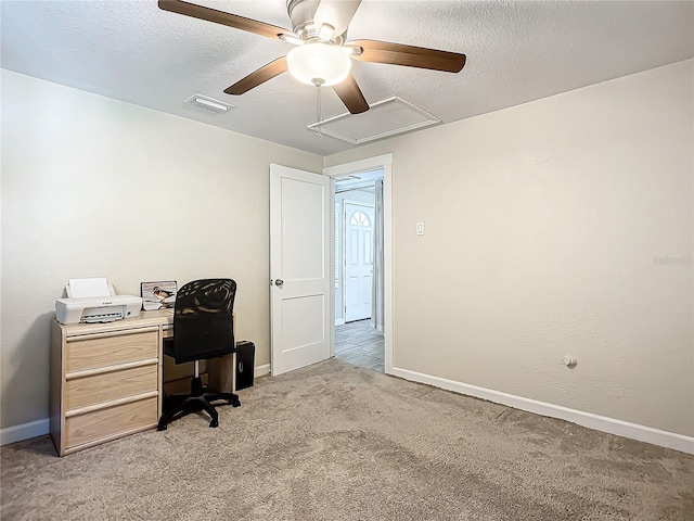 office with a textured ceiling, light colored carpet, and ceiling fan