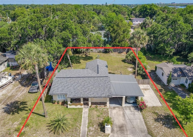 drone / aerial view featuring a wooded view