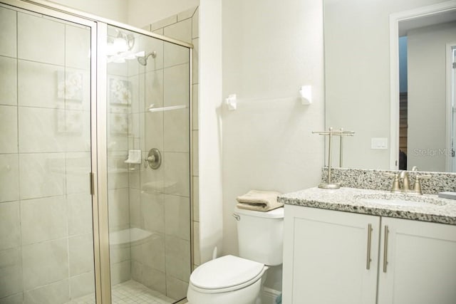 bathroom featuring walk in shower, vanity, and toilet