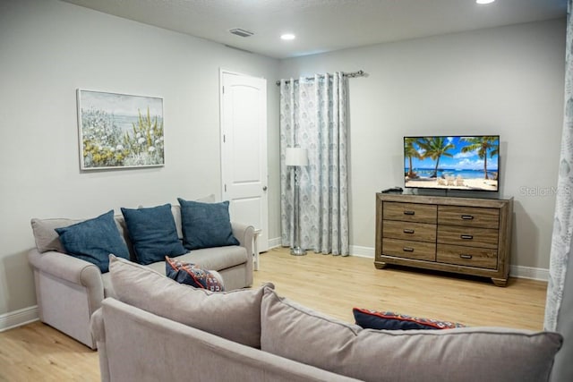 living room with light hardwood / wood-style flooring