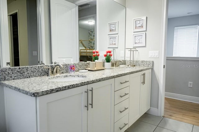 bathroom featuring dual bowl vanity and tile floors