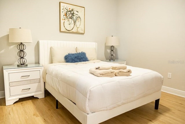 bedroom with wood-type flooring