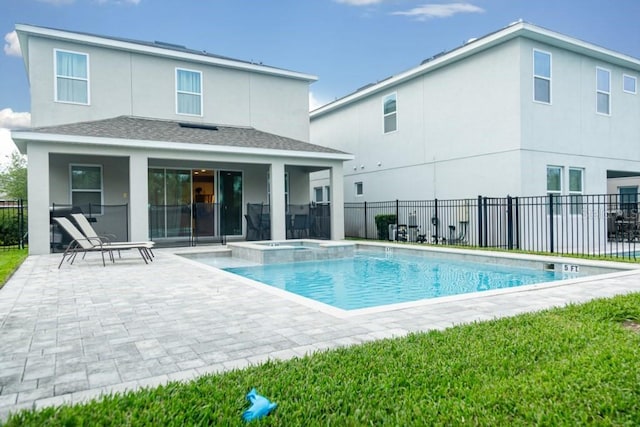 view of swimming pool with an in ground hot tub and a patio area