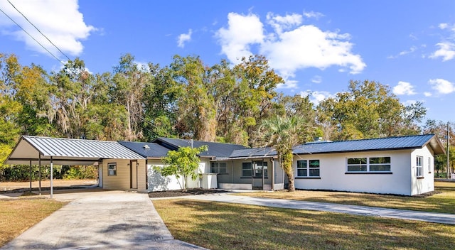 ranch-style home with a front lawn and a carport