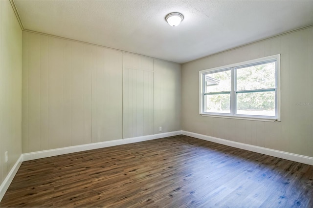 unfurnished room featuring dark wood-type flooring