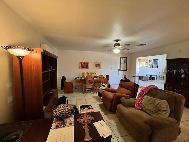 tiled living room featuring ceiling fan