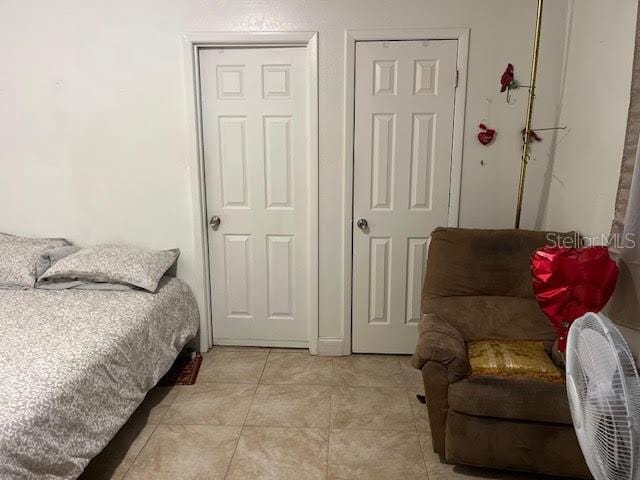 bedroom with light tile patterned flooring