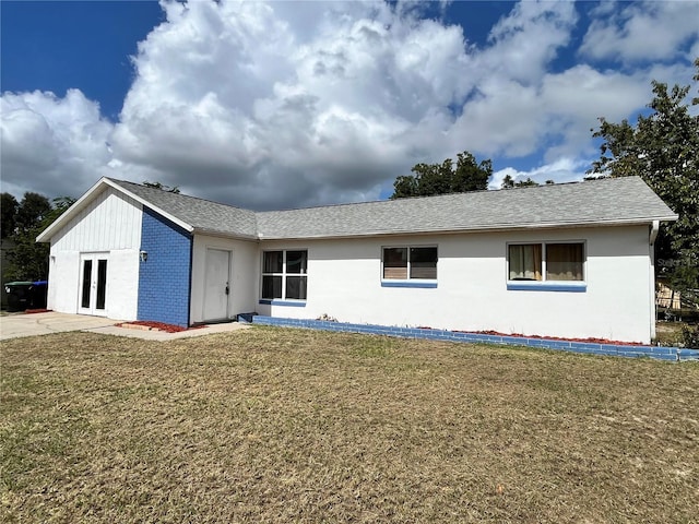 7313 Cabor Ct, Orlando, FL 32818 - view of front of home featuring brick siding, french doors, and a front yard