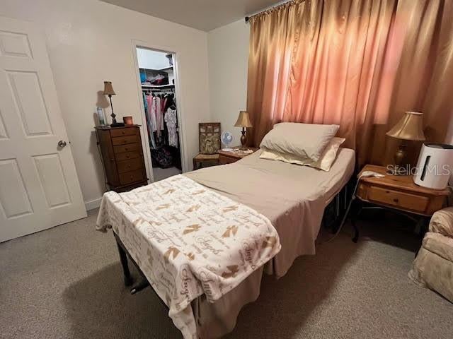7313 Cabor Ct, Orlando, FL 32818 - bedroom featuring a walk in closet, a closet, and carpet flooring