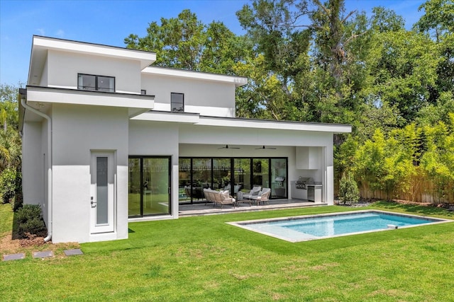 back of property with an outdoor living space, a yard, ceiling fan, and a fenced in pool