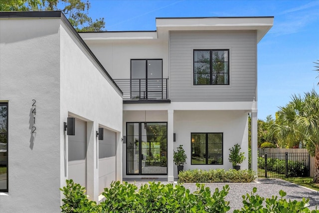 rear view of property featuring a balcony