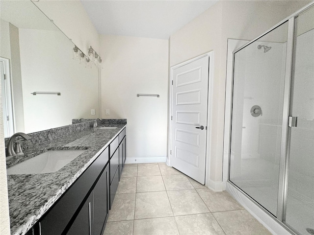 bathroom featuring tile floors, dual sinks, walk in shower, and large vanity