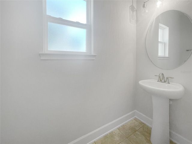 bathroom featuring a healthy amount of sunlight and tile floors