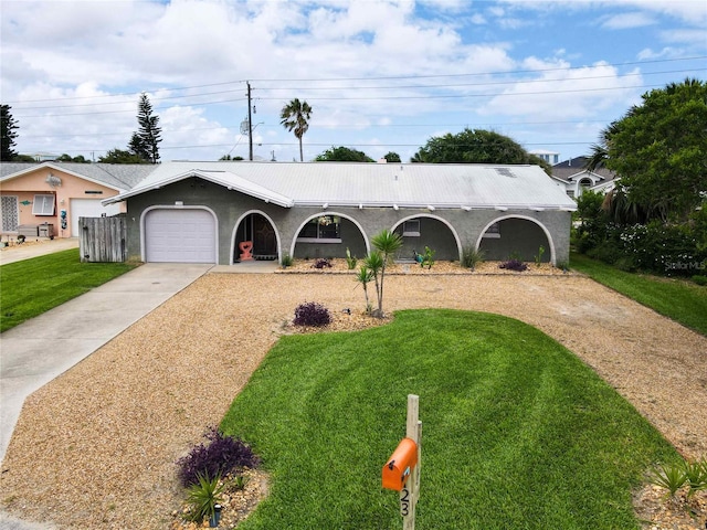 ranch-style house featuring a garage and a front lawn