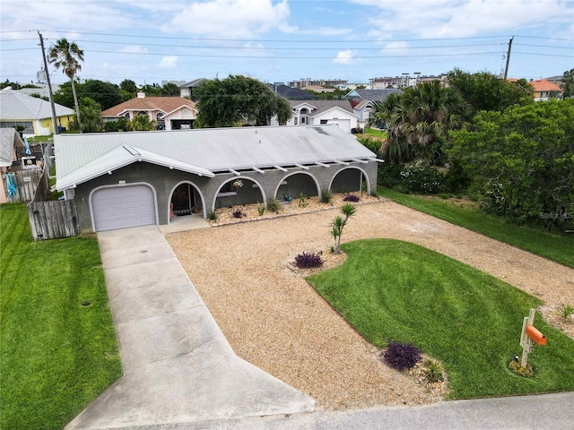 single story home with a front yard and a garage