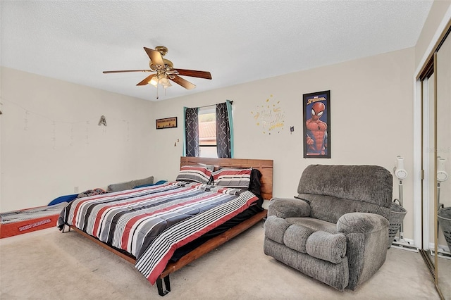 bedroom featuring a textured ceiling, a closet, ceiling fan, and carpet floors