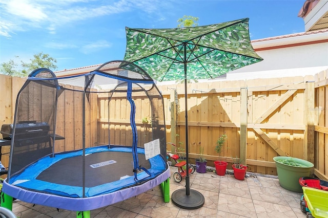 view of patio / terrace featuring area for grilling and a trampoline