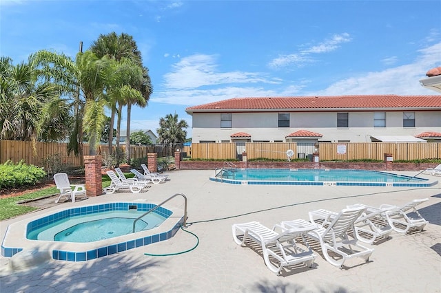 view of pool featuring a community hot tub and a patio