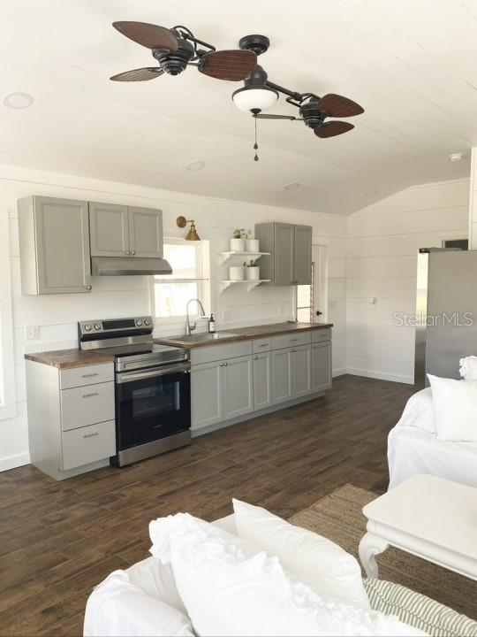 kitchen featuring appliances with stainless steel finishes, sink, dark hardwood / wood-style floors, and ceiling fan