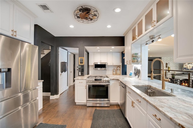 kitchen with white cabinetry, visible vents, appliances with stainless steel finishes, and a sink