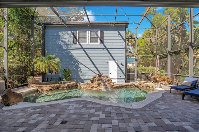 view of swimming pool featuring a lanai and a patio area