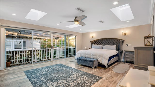 bedroom featuring access to exterior, wood finished floors, crown molding, and visible vents