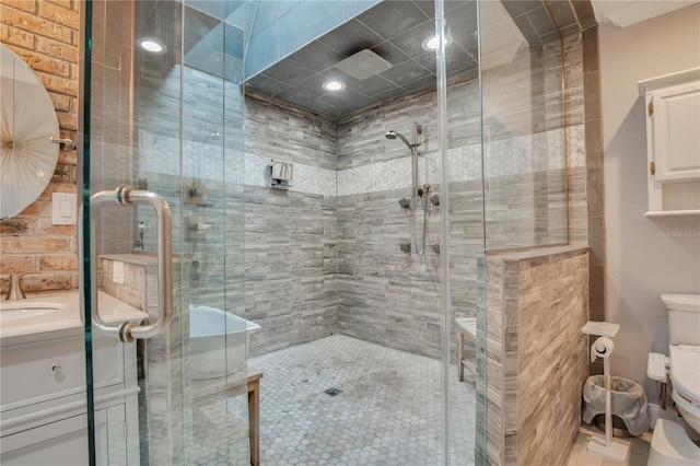 bathroom featuring a shower stall, toilet, and vanity