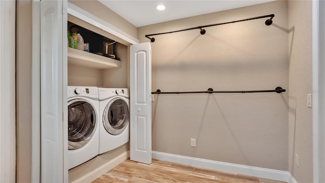 laundry room with laundry area, baseboards, and light wood-type flooring