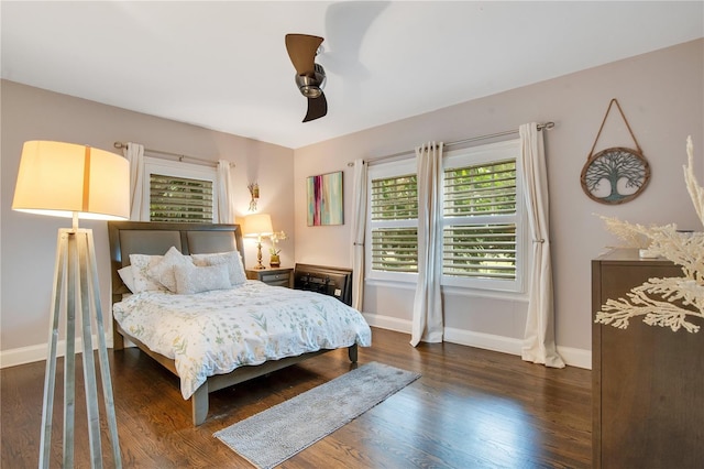 bedroom featuring baseboards, dark wood-style flooring, and ceiling fan