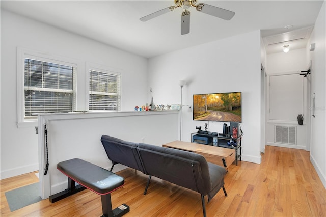 interior space with visible vents, light wood-style flooring, baseboards, and ceiling fan