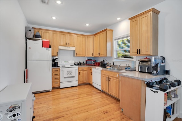 kitchen with light wood finished floors, light brown cabinets, white appliances, and under cabinet range hood