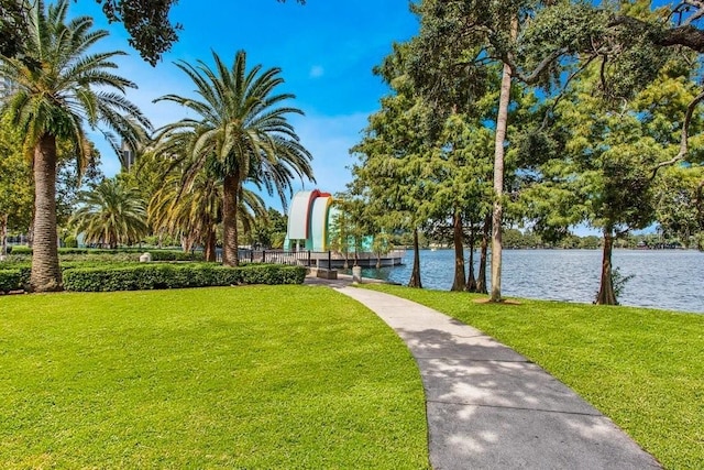 view of home's community with a yard and a water view