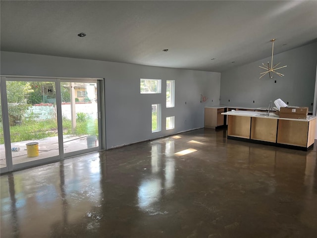 interior space featuring an inviting chandelier, sink, and vaulted ceiling