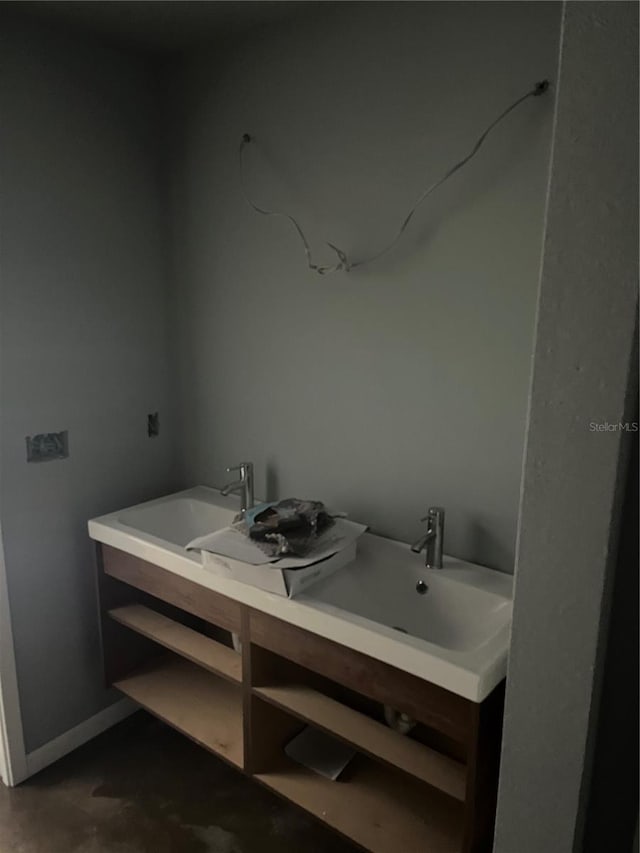 bathroom featuring concrete flooring and sink