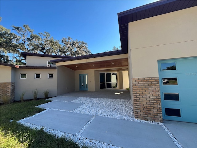 rear view of house featuring a carport