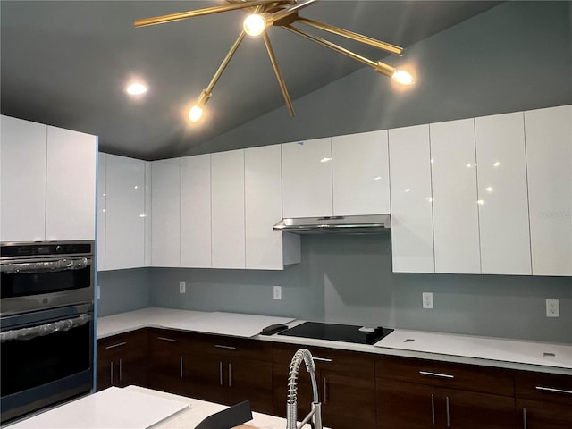 kitchen with white cabinetry, stainless steel double oven, stovetop, lofted ceiling, and dark brown cabinets