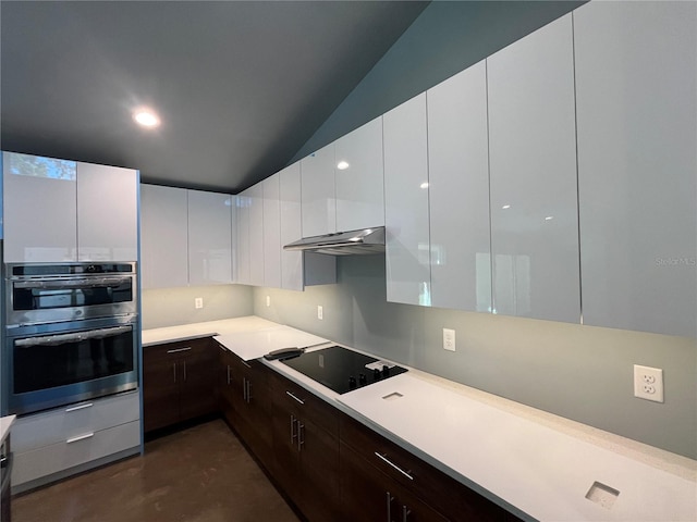 kitchen featuring dark brown cabinets, stainless steel double oven, black electric cooktop, vaulted ceiling, and white cabinetry