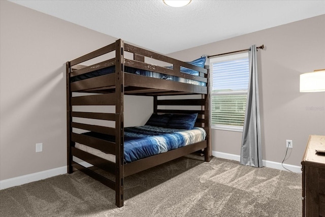 carpeted bedroom featuring a textured ceiling