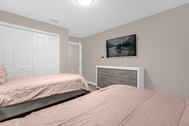 carpeted bedroom featuring a closet