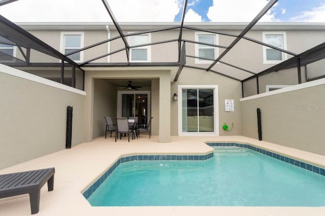 view of pool with ceiling fan, a patio, and a lanai