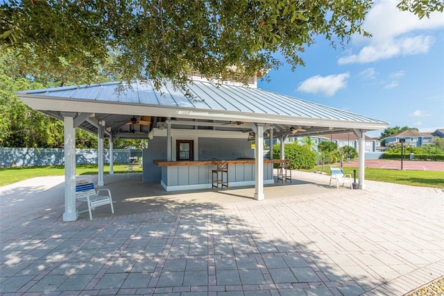 surrounding community featuring a bar and a gazebo