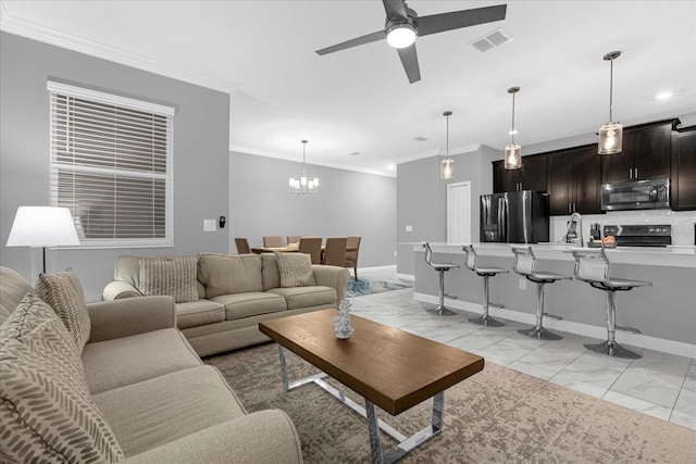 tiled living room featuring ceiling fan with notable chandelier and ornamental molding