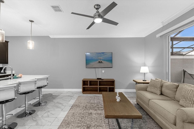 tiled living room featuring ceiling fan and ornamental molding