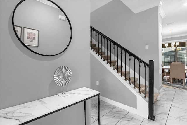 stairway with an inviting chandelier, crown molding, and tile patterned floors