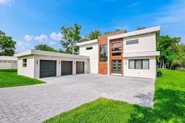 contemporary house featuring a garage and a front yard