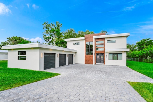 modern home featuring a garage and a front yard